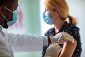 Woman_getting_a_flu_shot_during_COVID_19